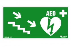 Znak AED w prawo schodami w dół