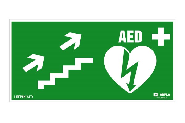 Znak AED w prawo schodami w górę